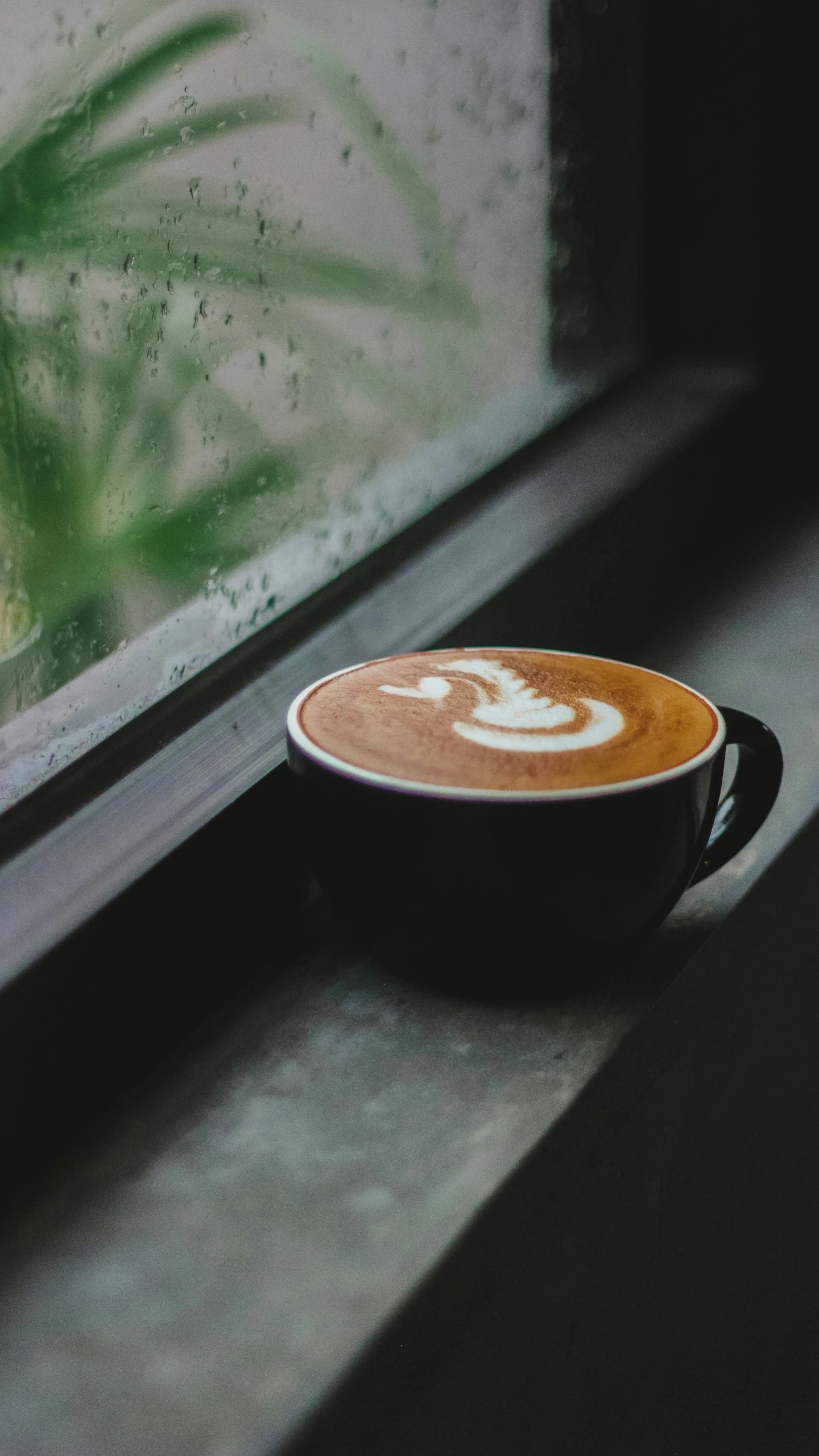 a brown cup sitting in front of a window