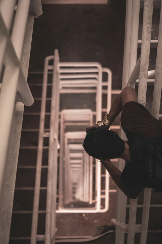 a person standing on top of a metal staircase