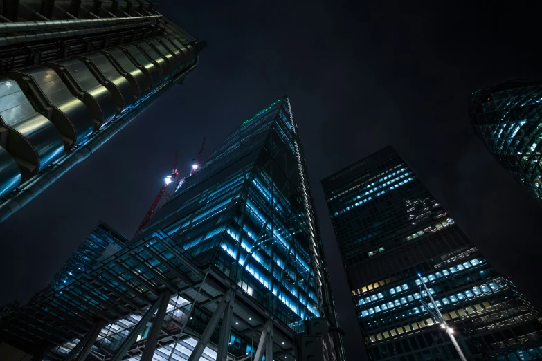 the skyscrs of london are glowing with light at night