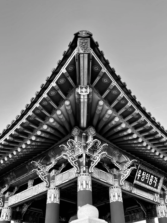 the roof of a very large building with columns and a clock