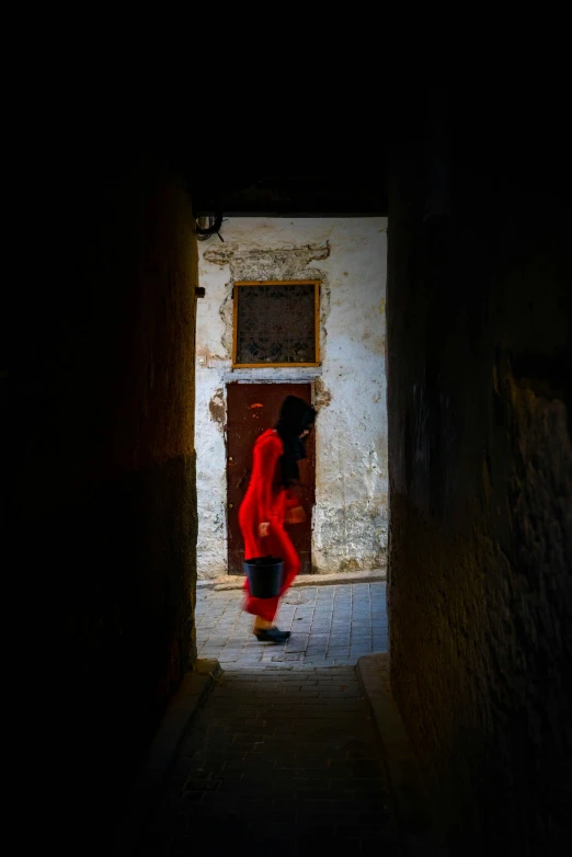 a woman in red standing in the doorway