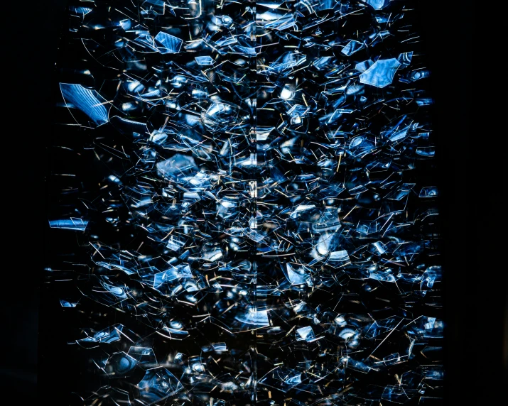 large amount of glass pieces in a dark area