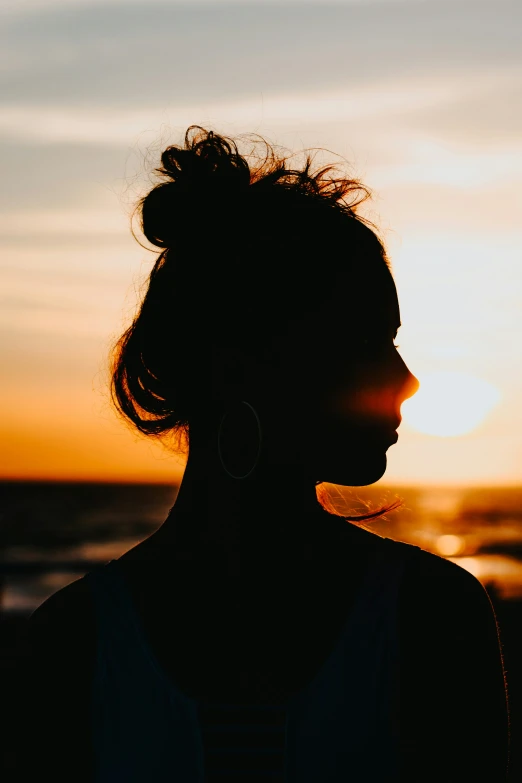 a female with her hair pulled in an under bun