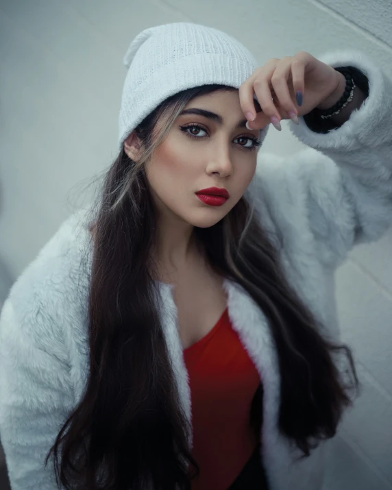 a girl with dark hair and wearing a white jacket