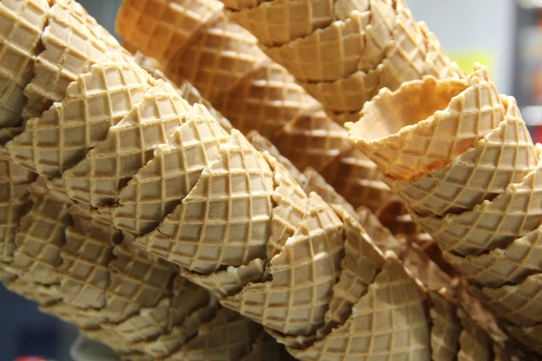 a pile of waffle cones sitting on top of a table