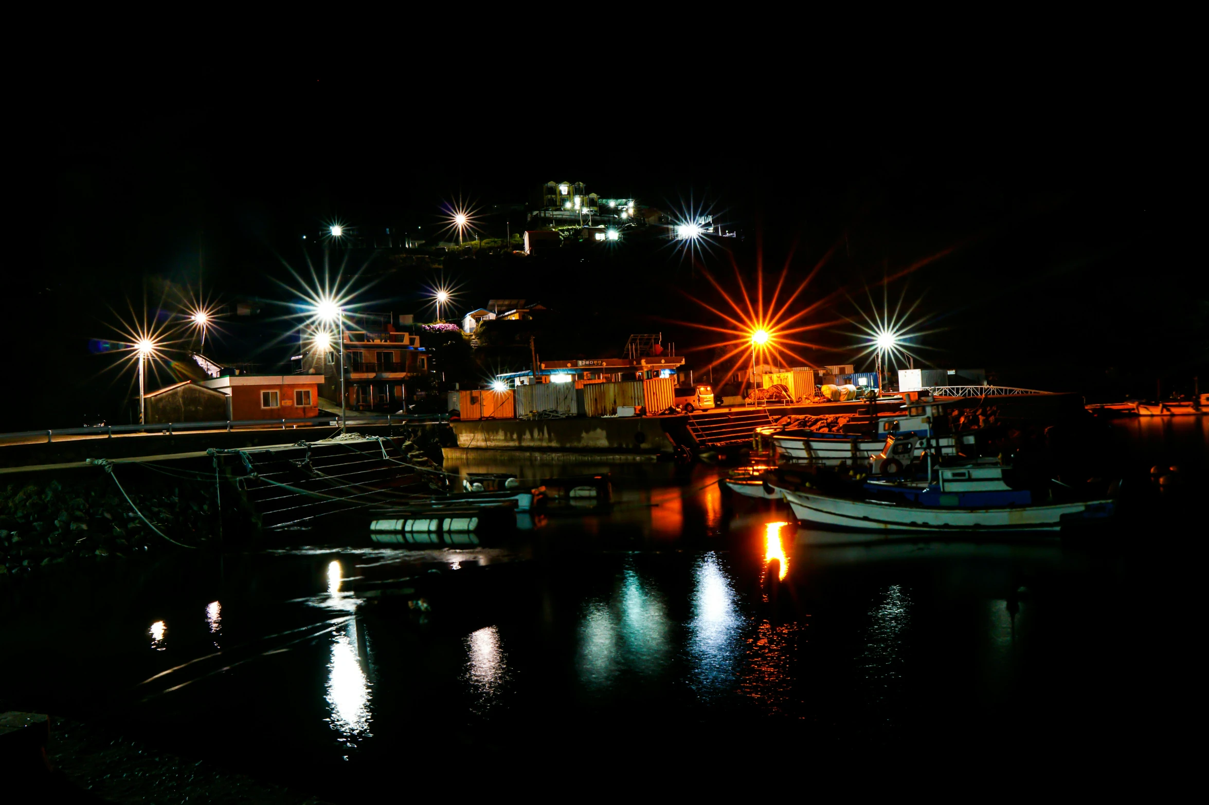 boats parked near docks at night on clear day