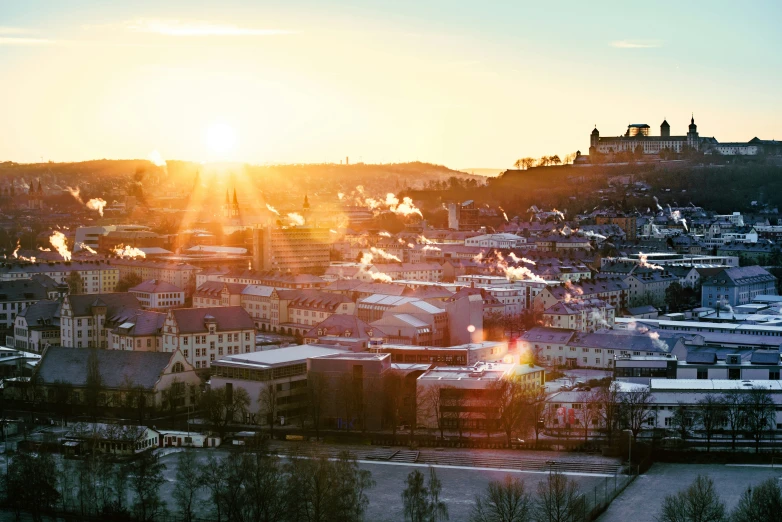 an overview of a city area with buildings and a large hill in the distance