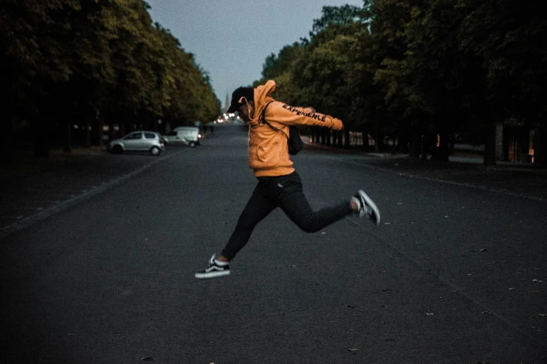 a person jumps in the air on the road