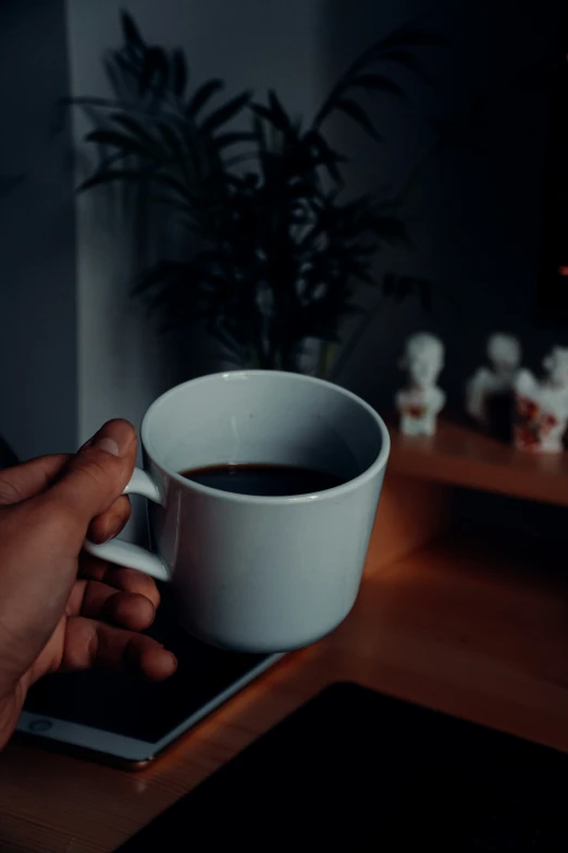 someone holding a cup of coffee on a tablet