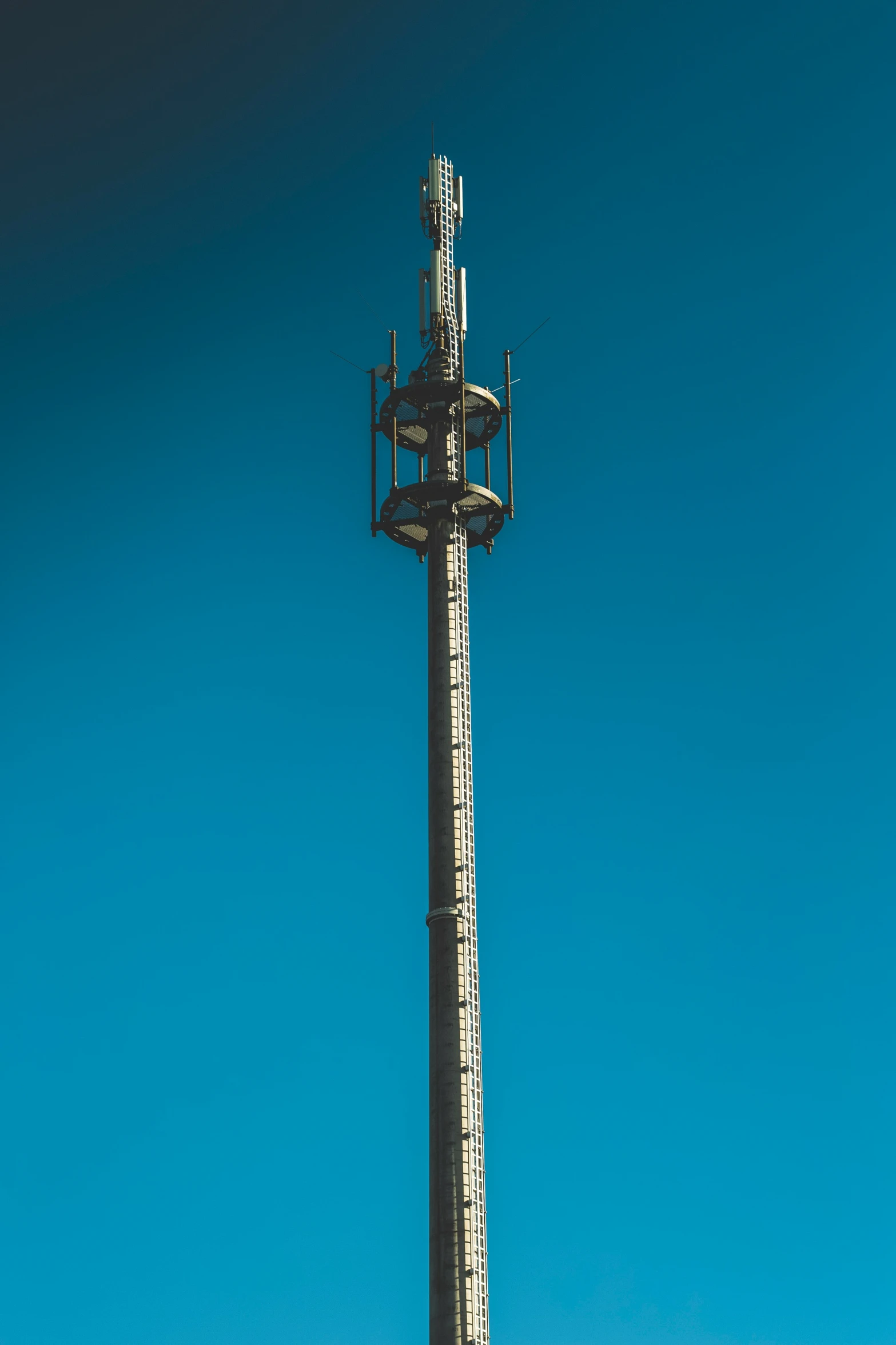 a tall pole with a large white clock on top