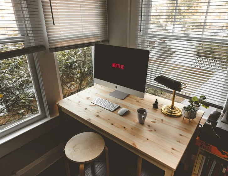 a small desk with a laptop computer sitting on top of it