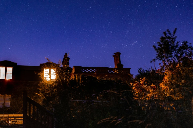 a view of a house at night from outside it