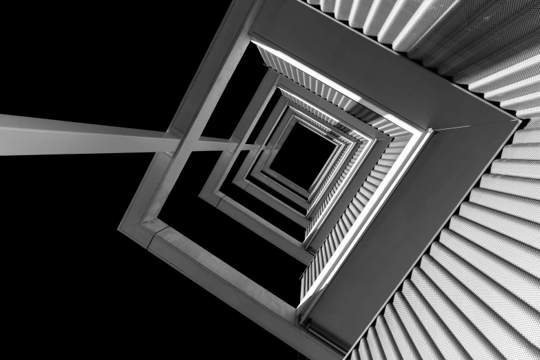 a view looking up at an opening in a metal structure