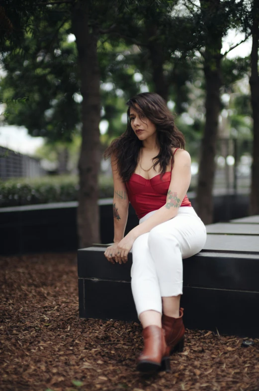 a girl wearing a red top and white pants