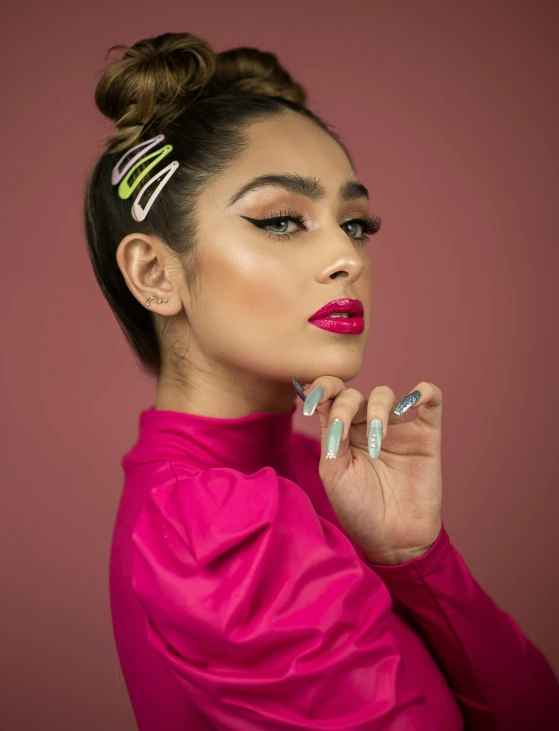 a close up view of a woman with multi colored nails