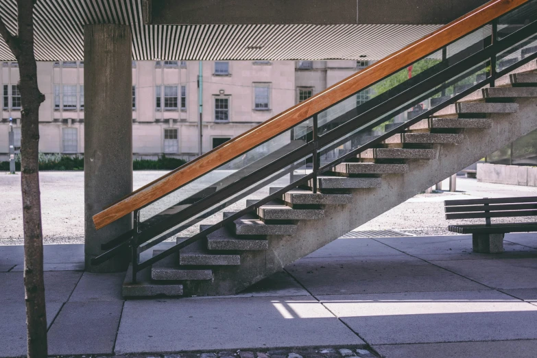 the stairway is going up next to a bench