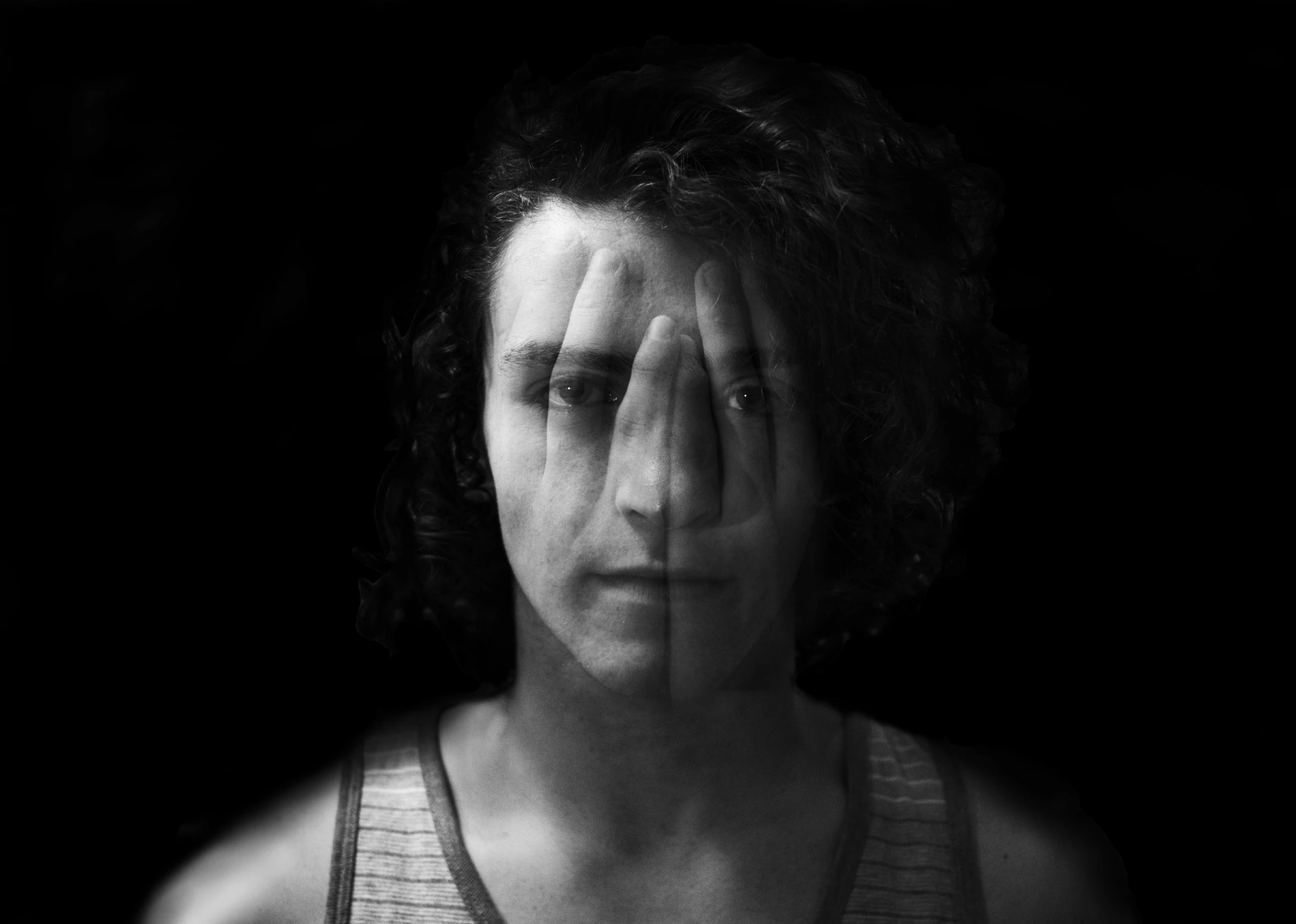 black and white pograph of a woman with hands on her face