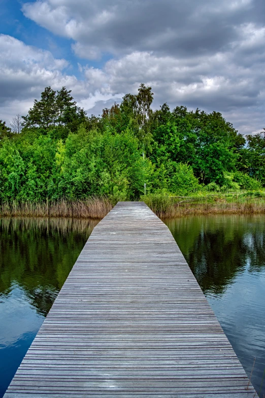 a long boardwalk stretching into the distance through a body of water