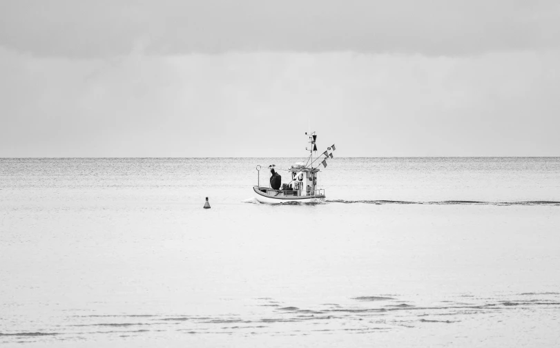 the boat in the middle of the water is waiting to go out