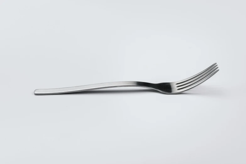 a black fork that is on a white surface