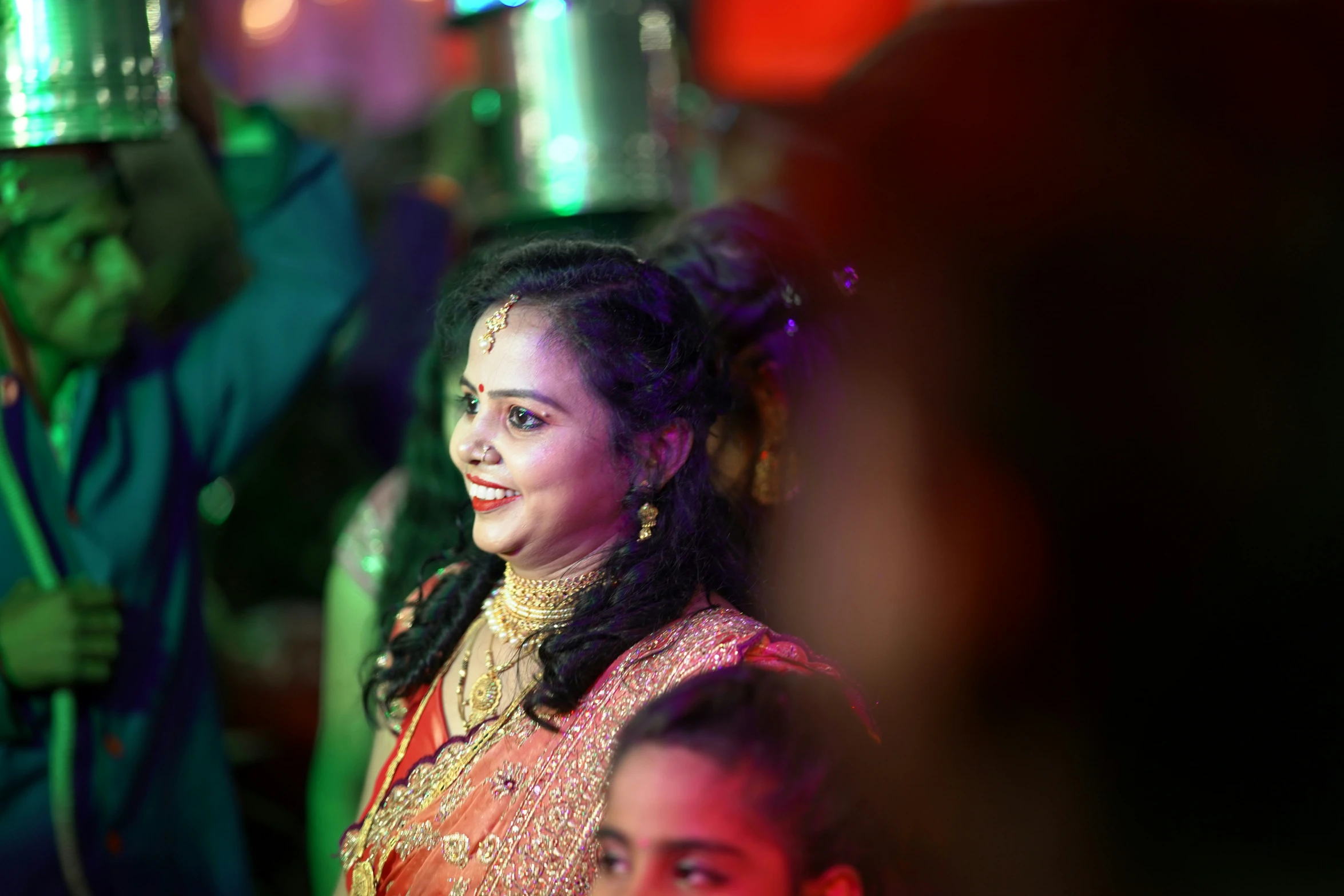 a woman in a traditional indian dress holding an umbrella