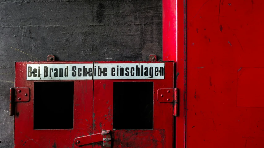 a red door with a white and black sign on it