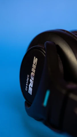 black cascoe headphones against blue background