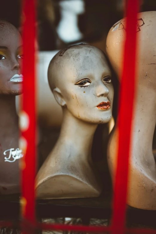 a head of a mannequin with a red line around it and other dummyes