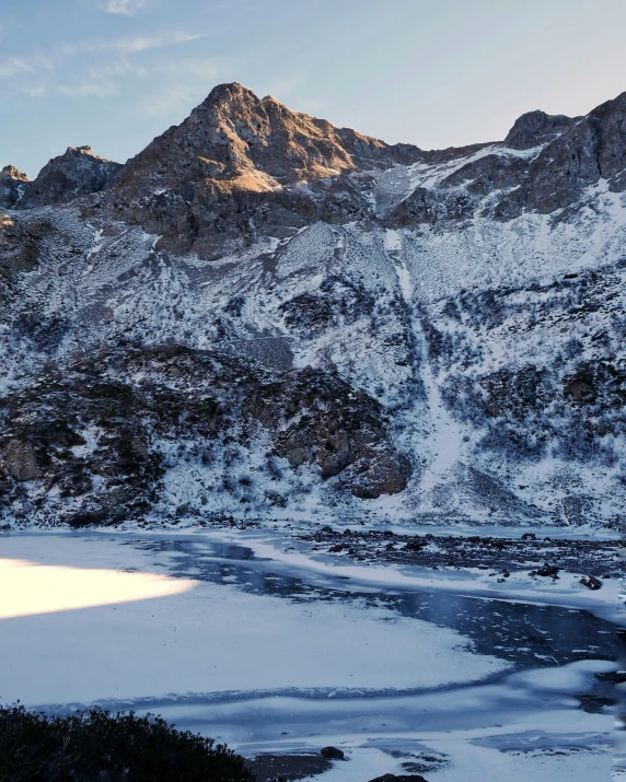 the snow covered mountains reflect bright light in the sunlight