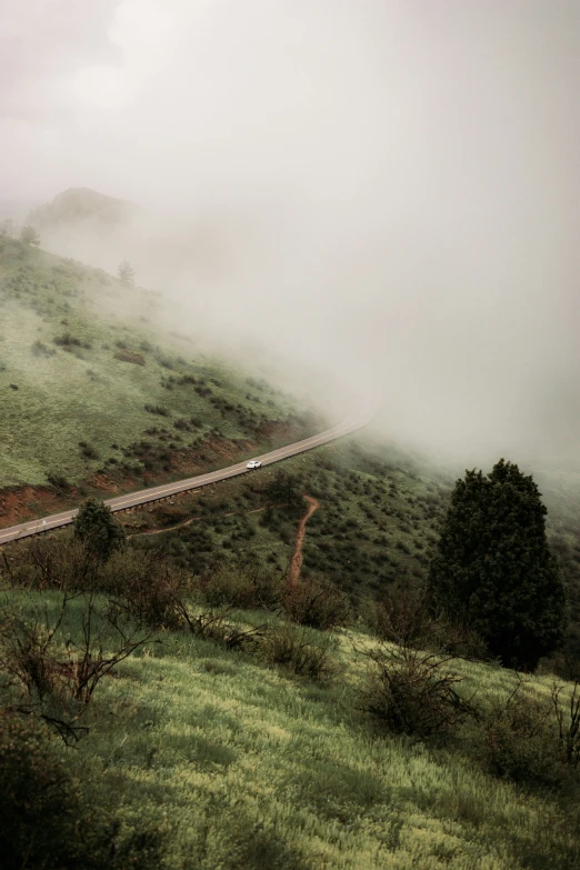 train tracks stretching through fog and cloud in the countryside