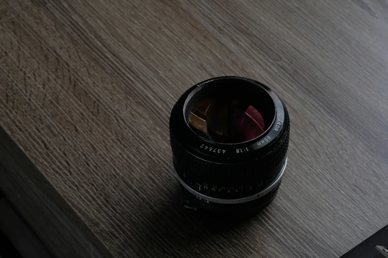 a small object is resting on top of a wooden desk