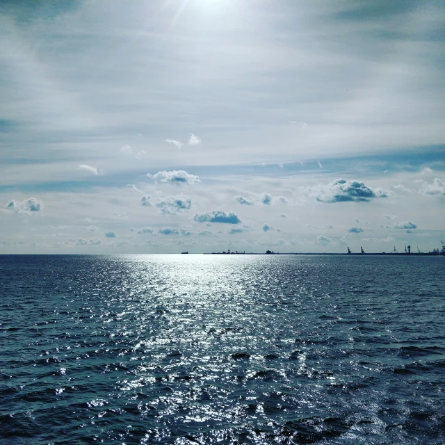 there is a blue body of water and a sky that is partly covered by clouds