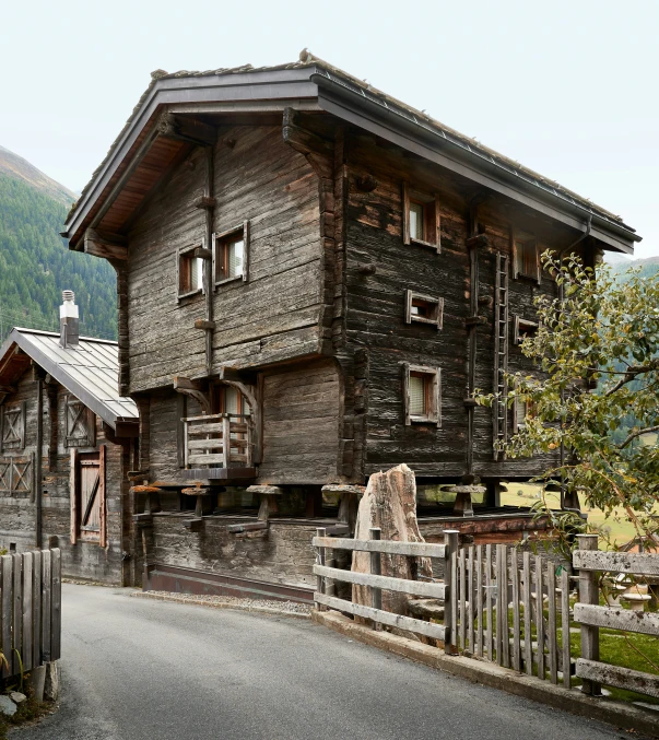 a old stone house with stone walls and metal roof