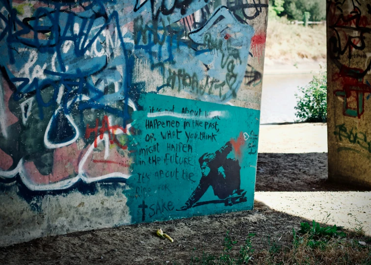 some graffiti spray painted on the side of a concrete wall