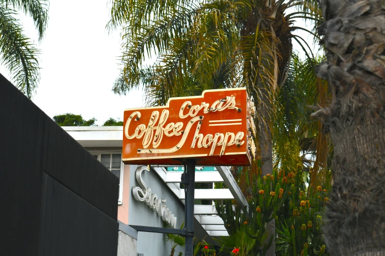 a orange sign sitting on the side of a building