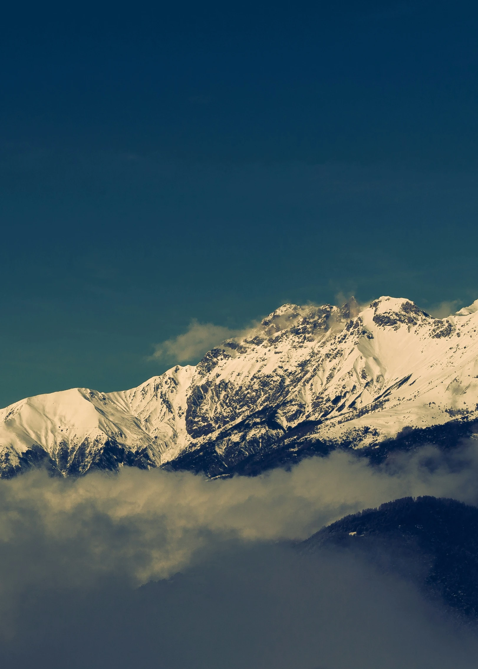 snow covered mountain peaks on a sunny day