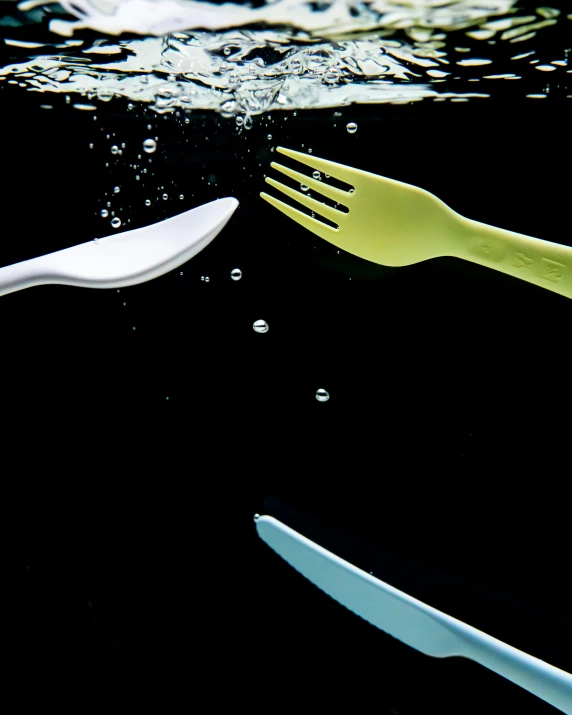 two forks and knife are shown in the water