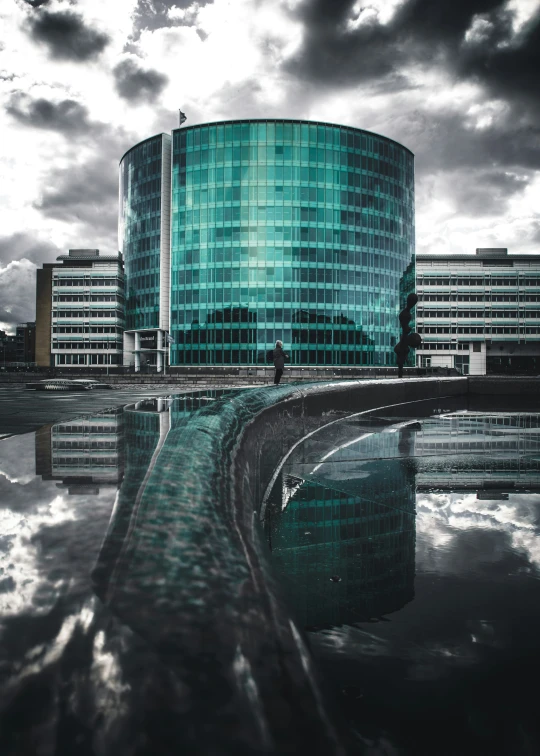 large building with very tall windows reflecting in water