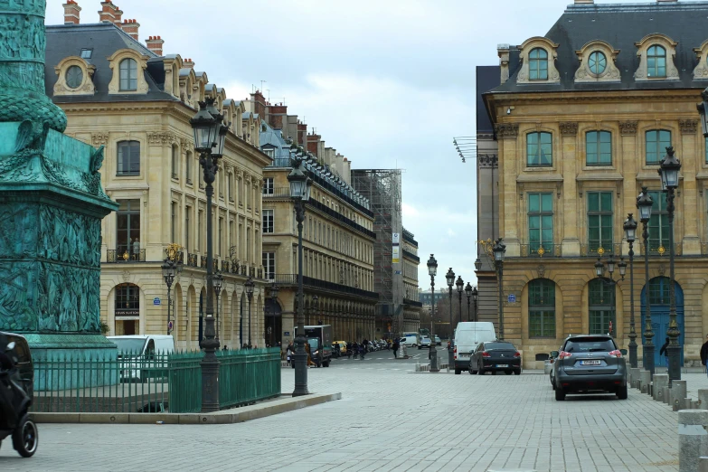 some cars sitting on the street in front of some buildings