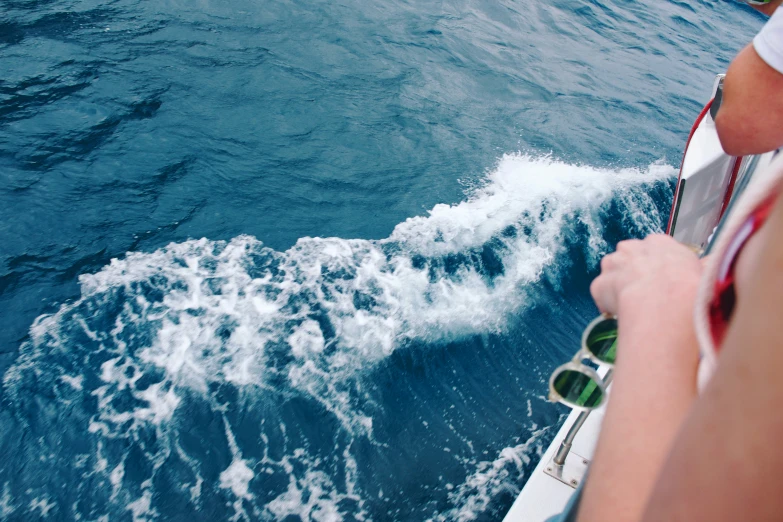 a closeup of the water with a person in a boat