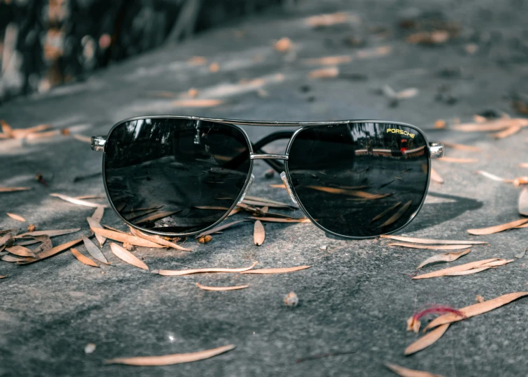 a pair of black sunglasses sitting on the ground