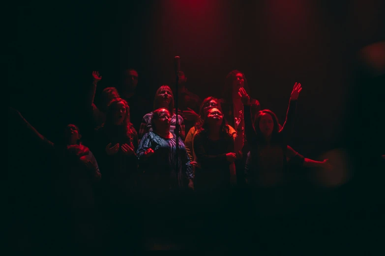 a large group of people standing in front of red lights