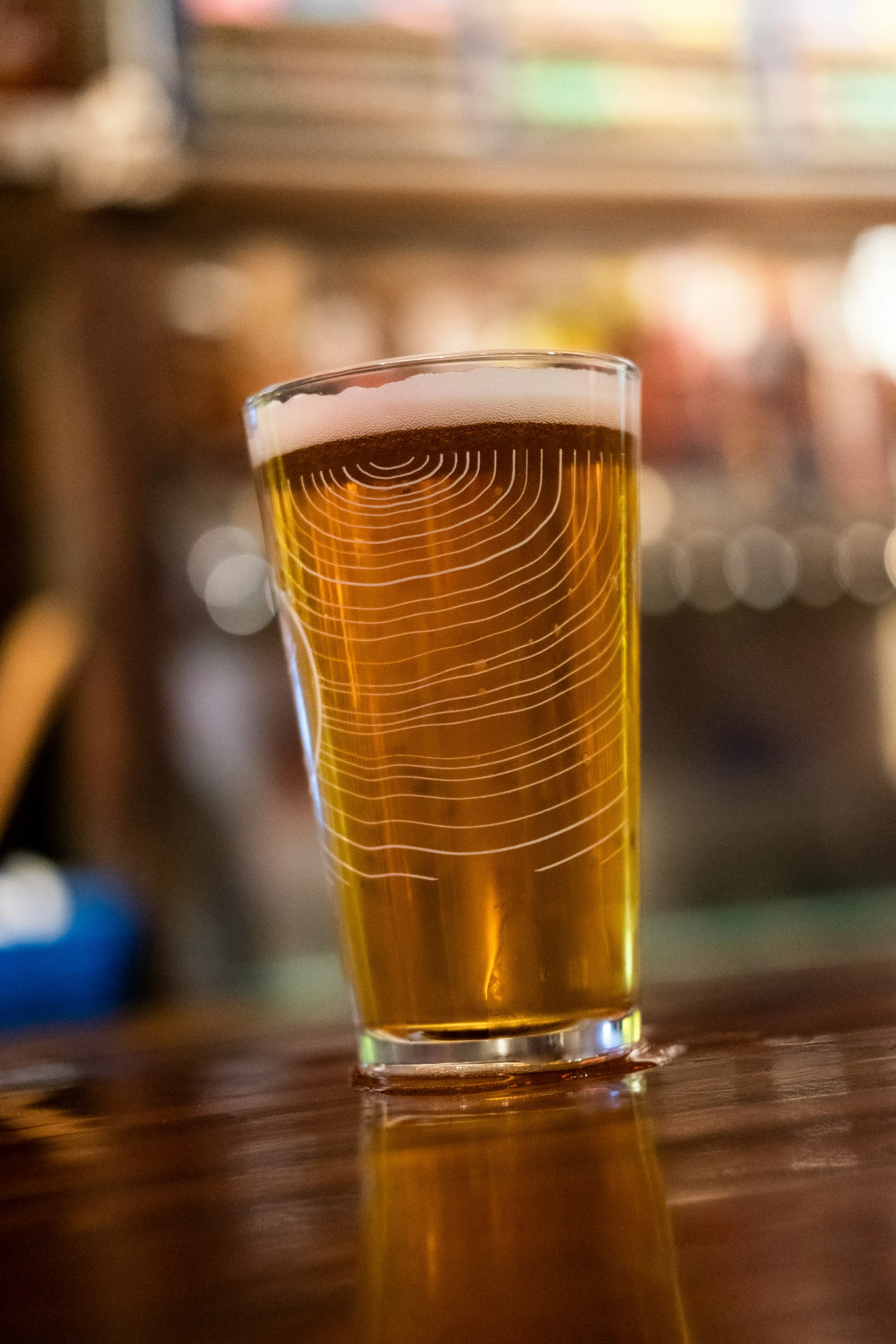 a glass with some beer sitting on a table