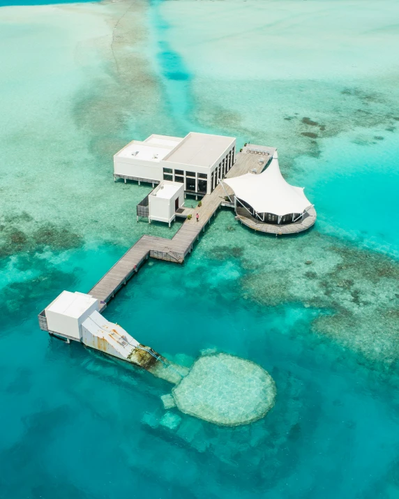 a house that is floating on some clear water