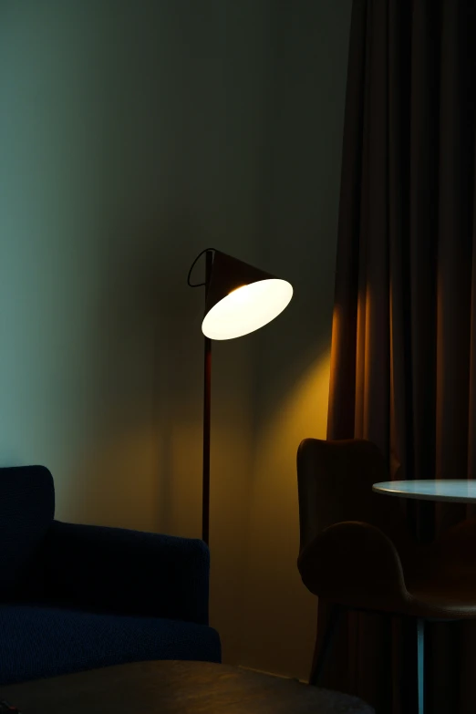 a lit up lamp in the corner of a room