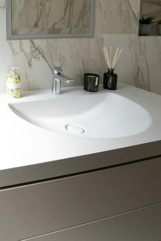 a bathroom sink with soap, toothbrushes and soap dispenser