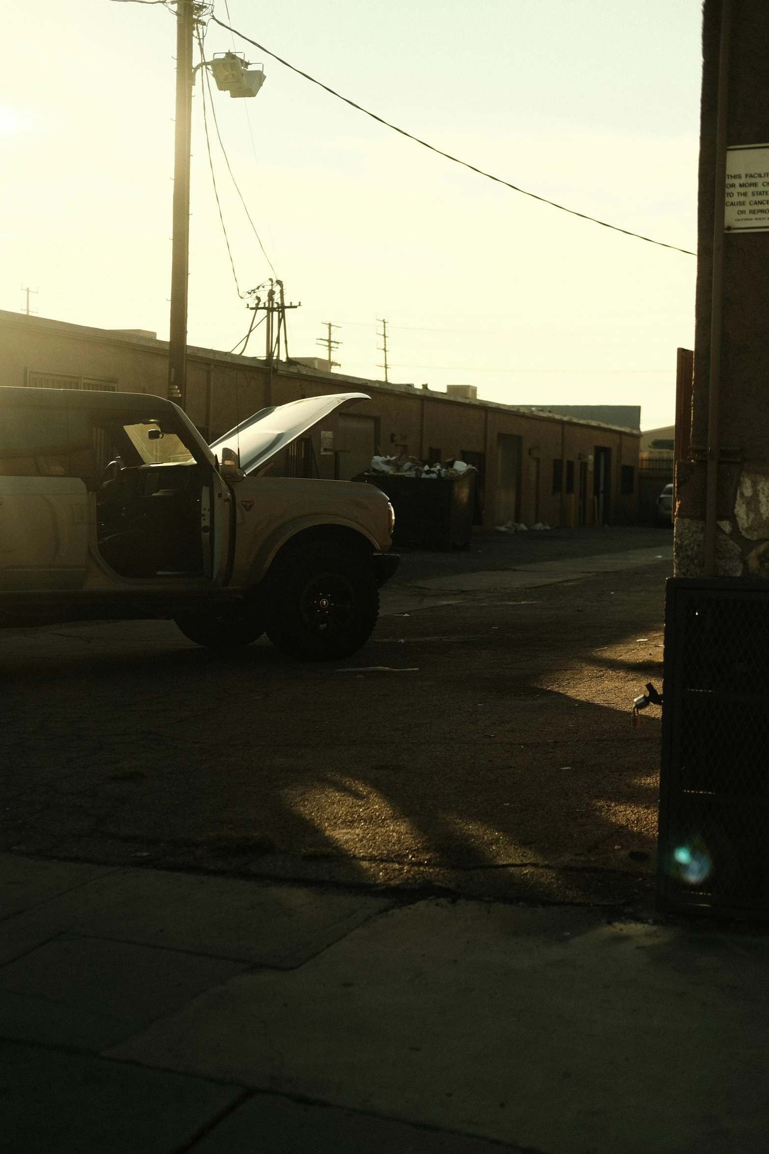 the back of a truck on a road near power lines