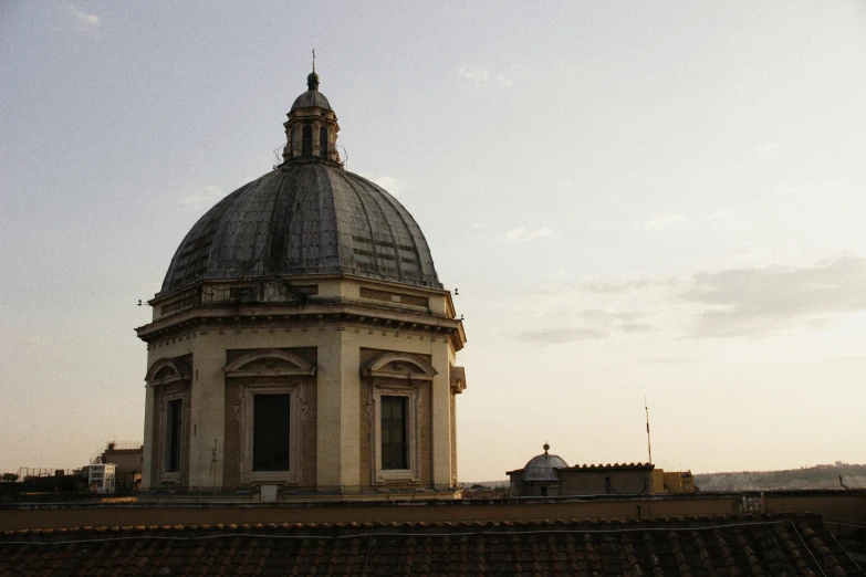 a building with a dome sitting on top of a roof