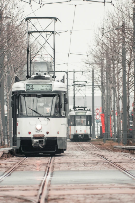 a white train is driving down the tracks