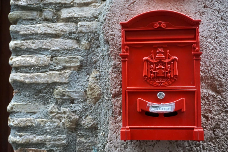 a red post box with a coat of arms on it